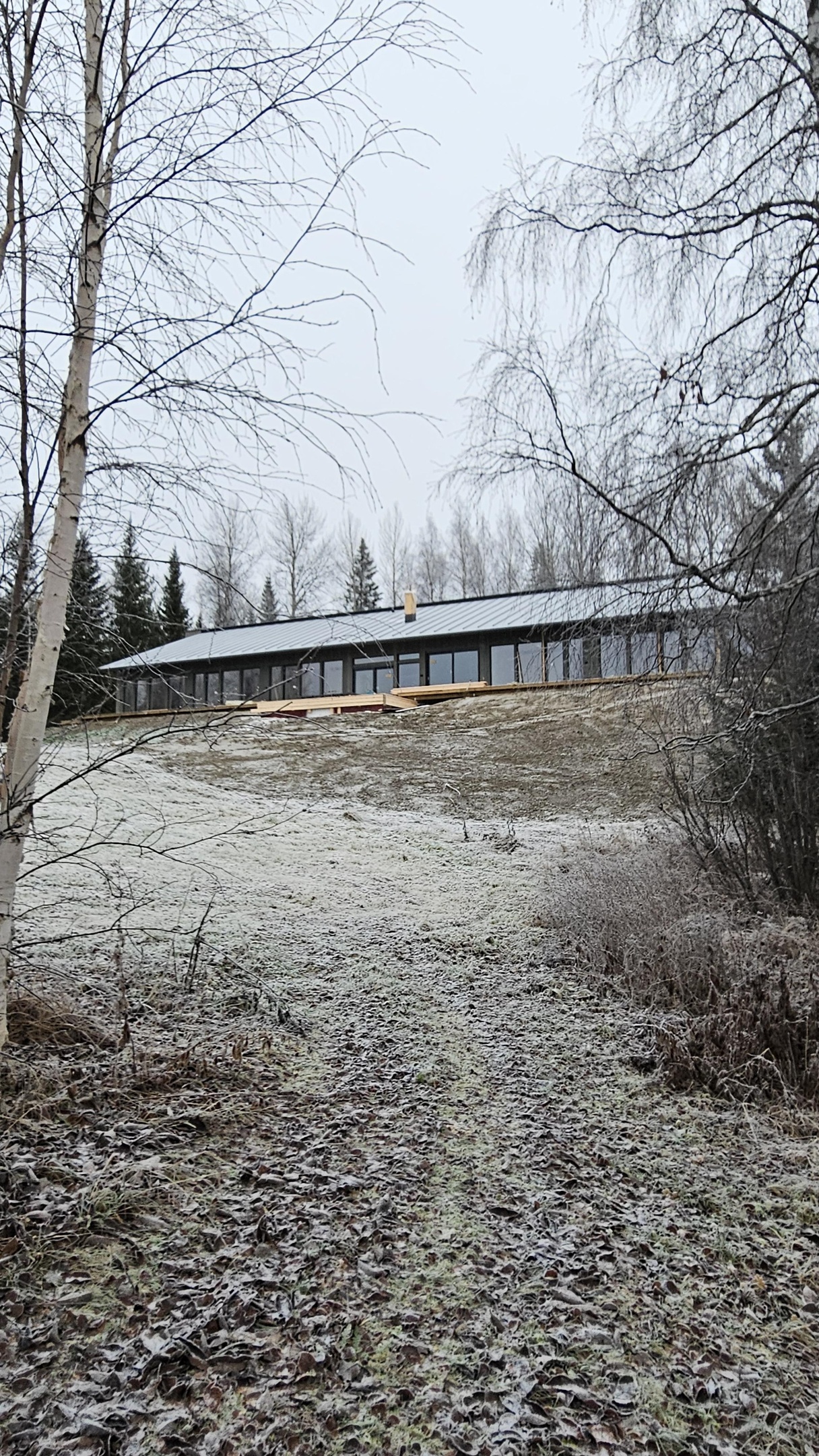 Snowy landscape, frozen trees and open water on the river